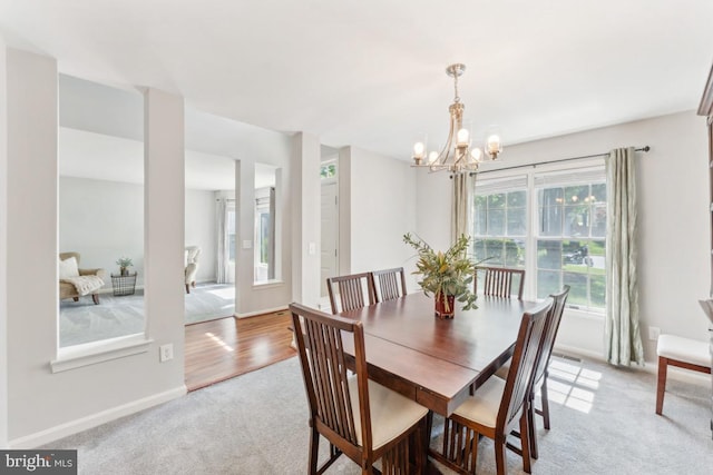 13213 Windy Leaf Ct, Woodbridge, VA 22192 - dining space featuring baseboards, an inviting chandelier, light carpet, and visible vents