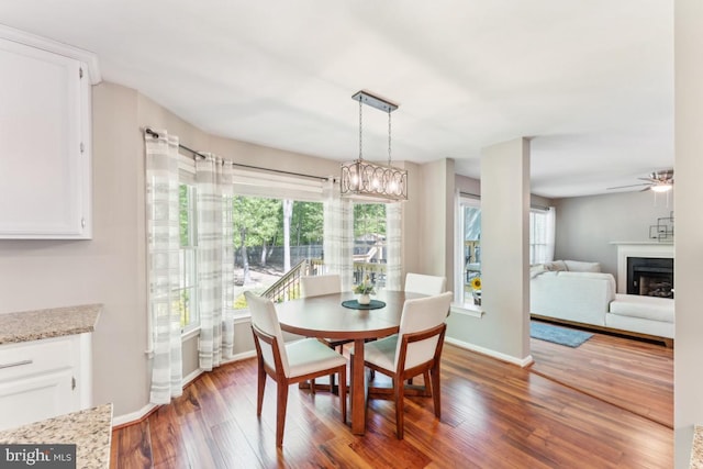 13213 Windy Leaf Ct, Woodbridge, VA 22192 - dining space featuring baseboards, ceiling fan, wood finished floors, and a fireplace