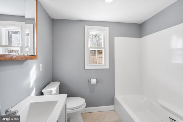 full bathroom with a bathtub, baseboards, vanity, toilet, and marble finish floor
