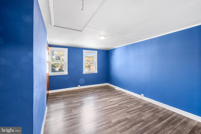 unfurnished room featuring baseboards and wood finished floors