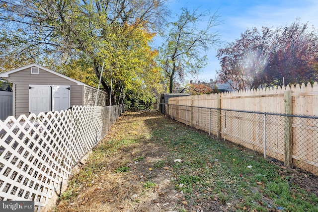 view of yard featuring a fenced backyard and a storage shed