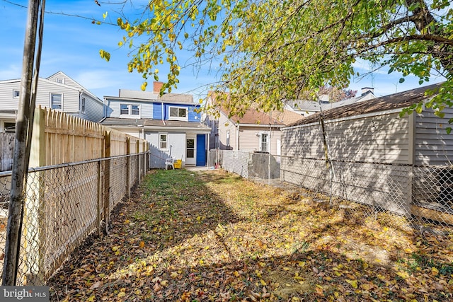 back of house featuring a fenced backyard