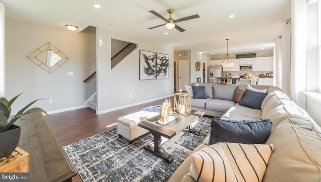 living area featuring ceiling fan, stairs, recessed lighting, baseboards, and dark wood-style floors