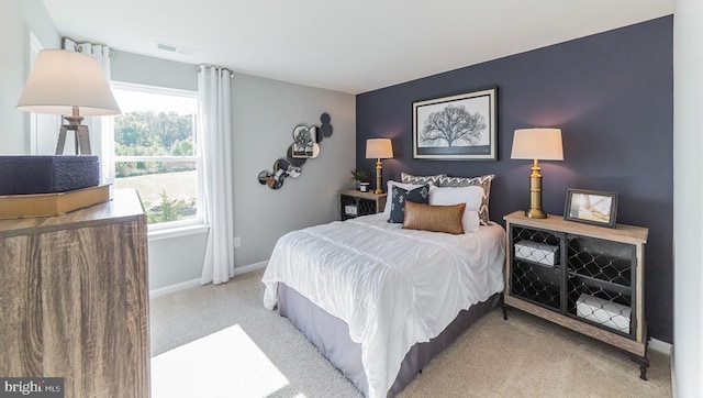 bedroom with baseboards, carpet, and visible vents