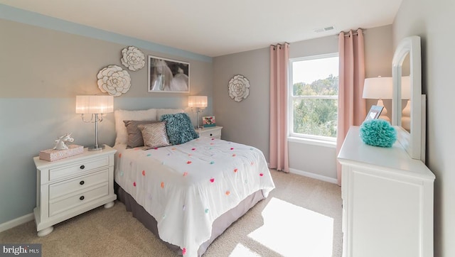 bedroom featuring baseboards, visible vents, and light carpet