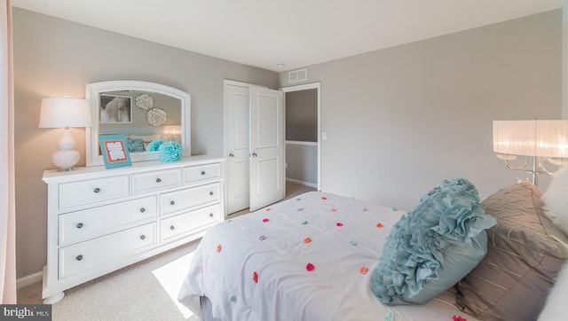 carpeted bedroom featuring visible vents and baseboards