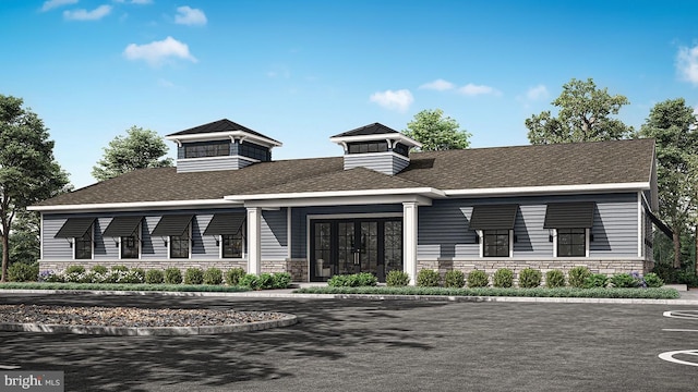 exterior space with french doors and stone siding