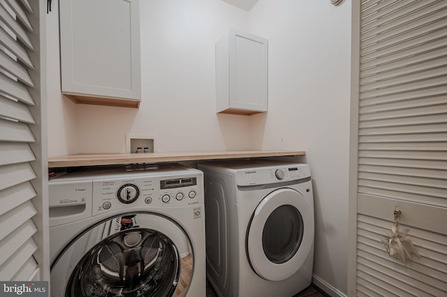 laundry room featuring washing machine and dryer and cabinet space