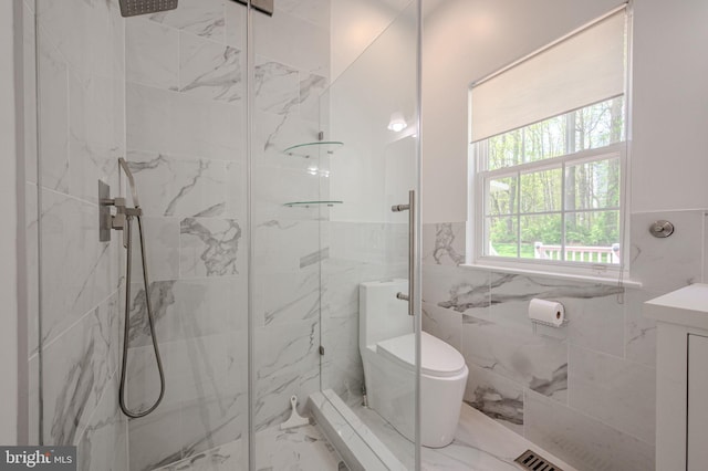 bathroom featuring toilet, tile walls, a marble finish shower, and marble finish floor