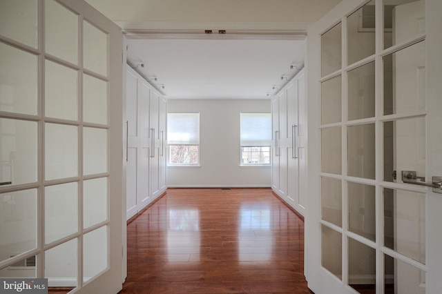 corridor with visible vents and wood finished floors