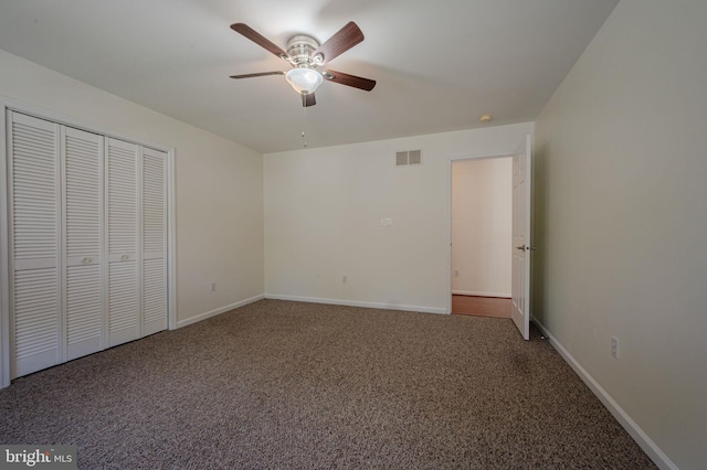 unfurnished bedroom with visible vents, carpet, baseboards, and a closet