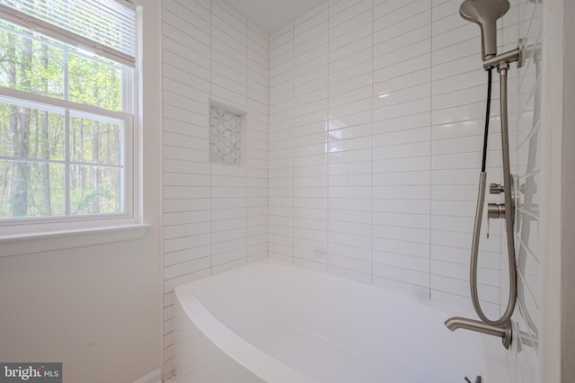 bathroom with shower / tub combination and plenty of natural light
