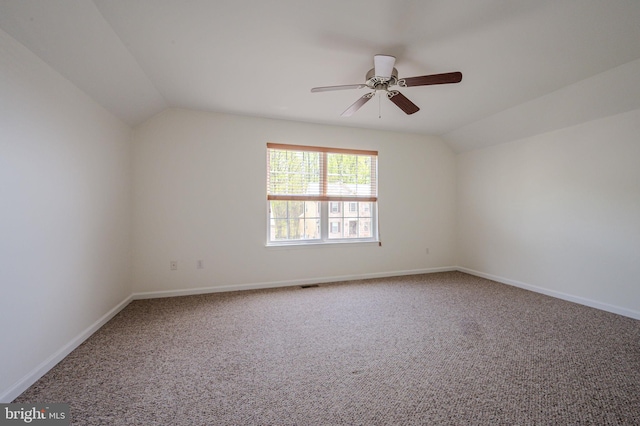 unfurnished room featuring ceiling fan, visible vents, baseboards, lofted ceiling, and carpet