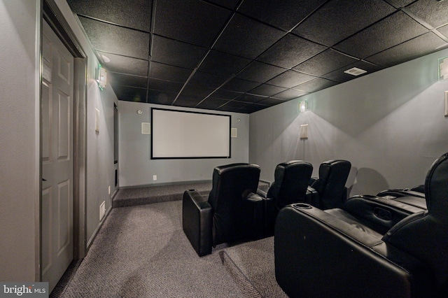 carpeted home theater featuring baseboards, visible vents, and a drop ceiling