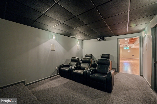home theater with carpet floors, baseboards, and a paneled ceiling