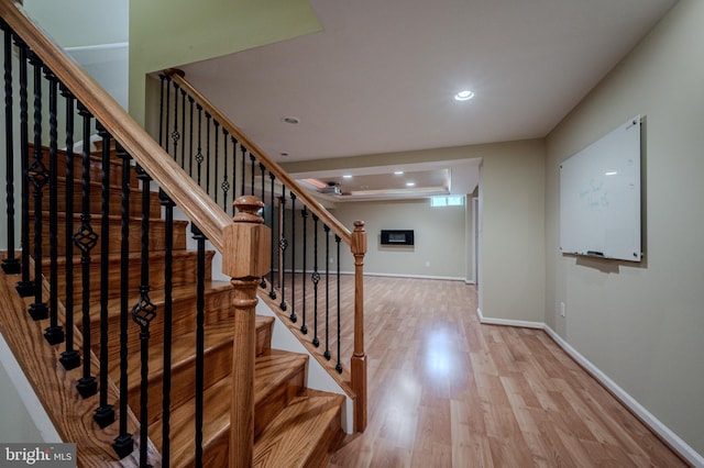 stairway with recessed lighting, baseboards, and wood finished floors