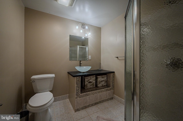 full bathroom featuring tile patterned flooring, a stall shower, vanity, baseboards, and toilet