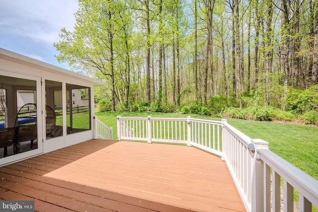wooden deck with a sunroom and a yard