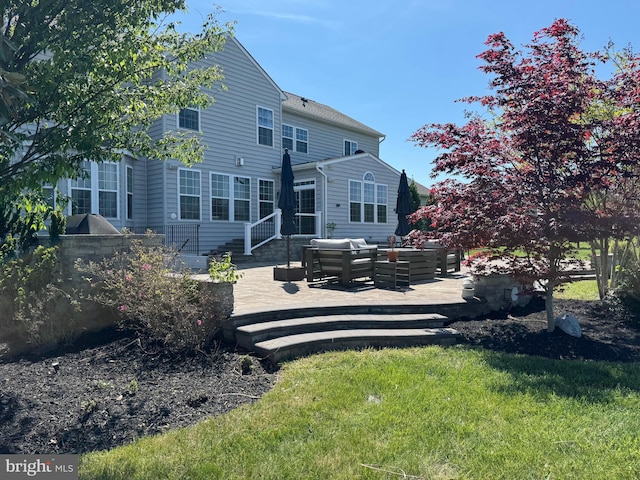 back of property featuring a lawn, outdoor lounge area, and a deck