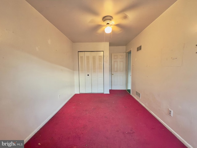 unfurnished bedroom with visible vents, carpet flooring, baseboards, and a closet