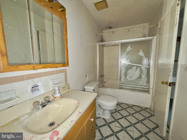 full bath featuring backsplash, tile patterned flooring, vanity, toilet, and shower / bath combination with glass door