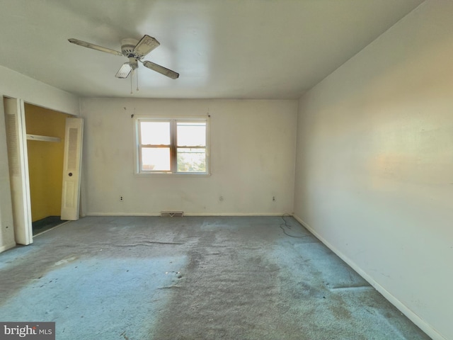 unfurnished bedroom with carpet floors, baseboards, and visible vents