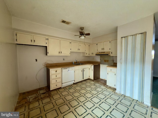 kitchen with ceiling fan, visible vents, dishwasher, light floors, and under cabinet range hood