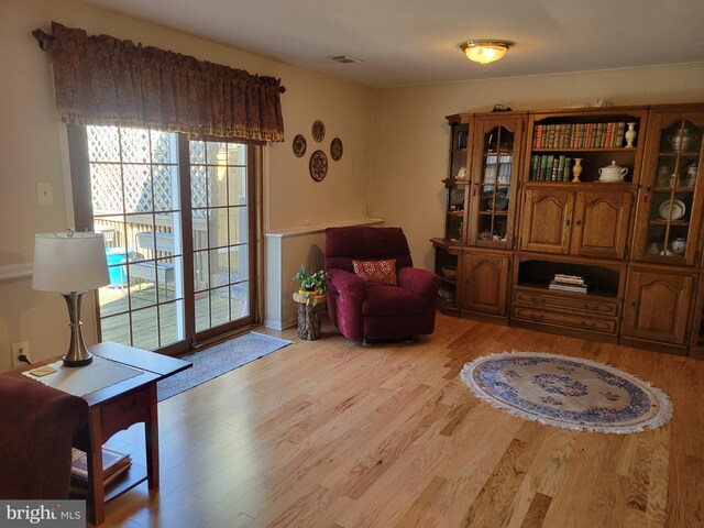 living area featuring visible vents and light wood-type flooring