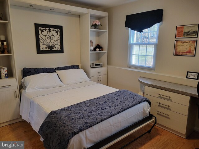bedroom with wood finished floors