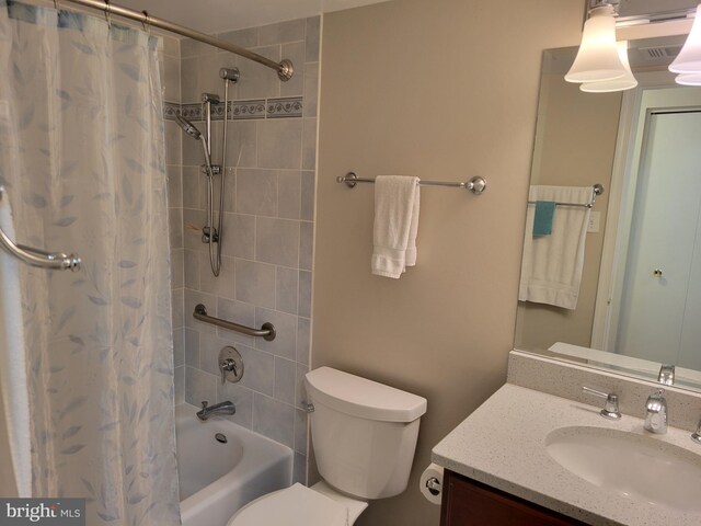 full bath featuring vanity, toilet, and shower / tub combo