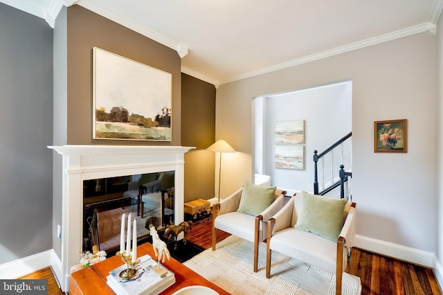 209 11th St NE, Washington, DC 20002 - sitting room with crown molding, wood finished floors, a glass covered fireplace, and baseboards