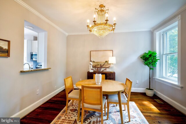 209 11th St NE, Washington, DC 20002 - dining space with a chandelier, baseboards, wood finished floors, and crown molding