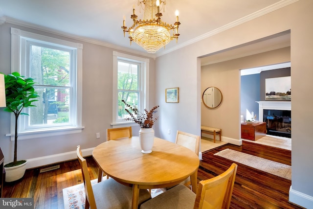 209 11th St NE, Washington, DC 20002 - dining area featuring healthy amount of natural light, baseboards, wood-type flooring, a chandelier, and crown molding