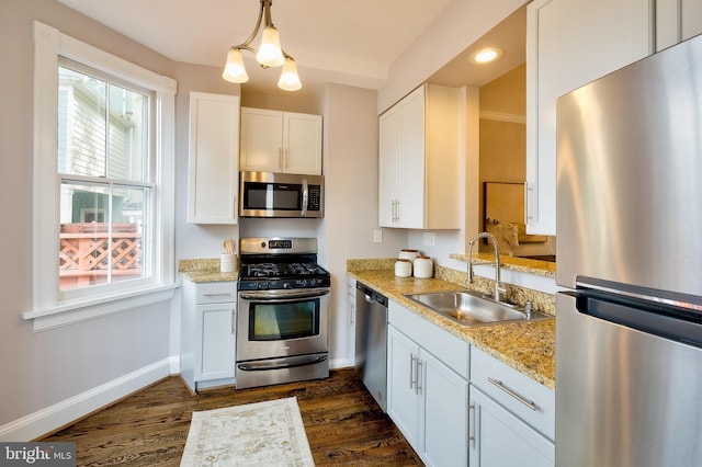 209 11th St NE, Washington, DC 20002 - kitchen featuring stainless steel appliances, a sink, dark wood-style floors, baseboards, and white cabinetry