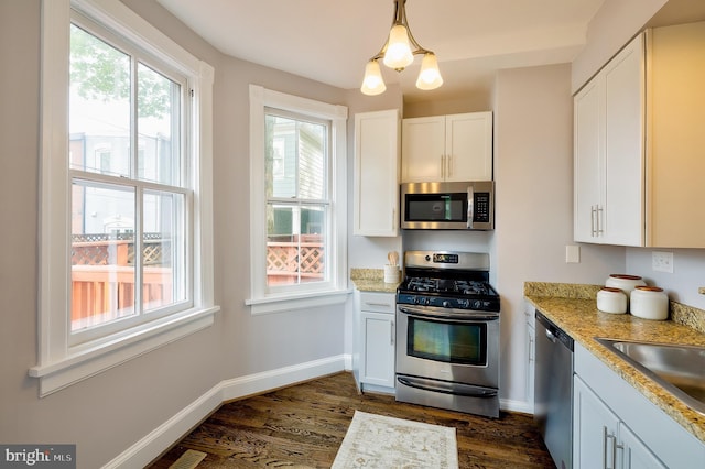 209 11th St NE, Washington, DC 20002 - kitchen featuring appliances with stainless steel finishes, dark wood-type flooring, a sink, white cabinets, and baseboards