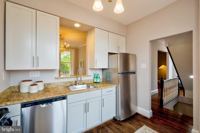 209 11th St NE, Washington, DC 20002 - kitchen with appliances with stainless steel finishes, a sink, a chandelier, dark wood-type flooring, and white cabinets