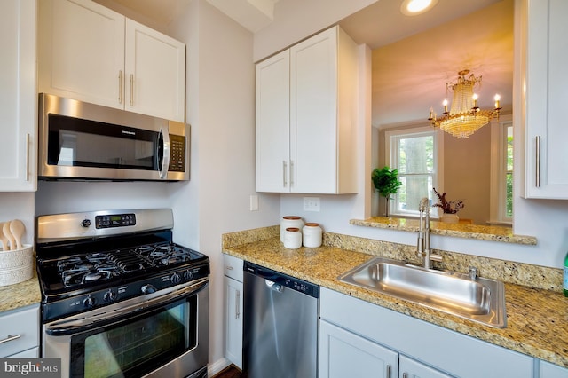 209 11th St NE, Washington, DC 20002 - kitchen featuring stainless steel appliances, a sink, a chandelier, and white cabinets