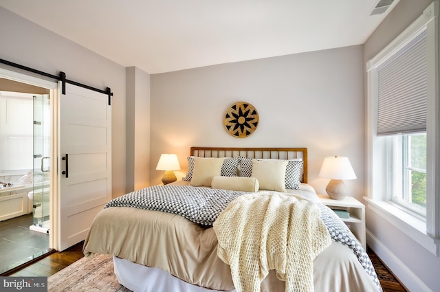 209 11th St NE, Washington, DC 20002 - bedroom with dark wood-type flooring, a barn door, and baseboards