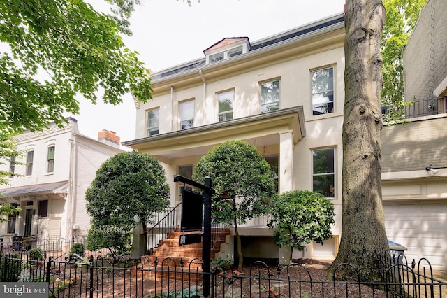 209 11th St NE, Washington, DC 20002 - view of property with a fenced front yard and stucco siding