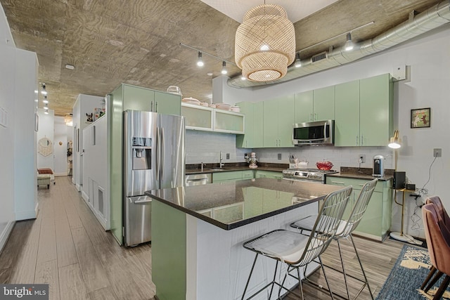 929 Florida Ave NW Unit 2001, Washington, DC 20001 - kitchen featuring green cabinetry, appliances with stainless steel finishes, a sink, and light wood-style floors