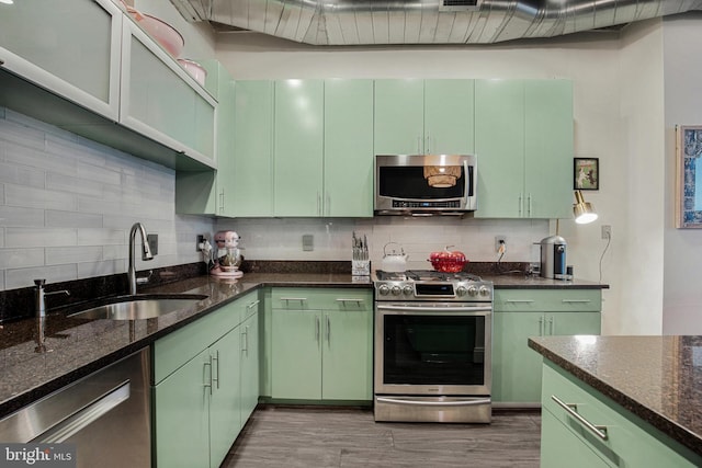 929 Florida Ave NW Unit 2001, Washington, DC 20001 - kitchen featuring a sink, tasteful backsplash, green cabinets, and stainless steel appliances