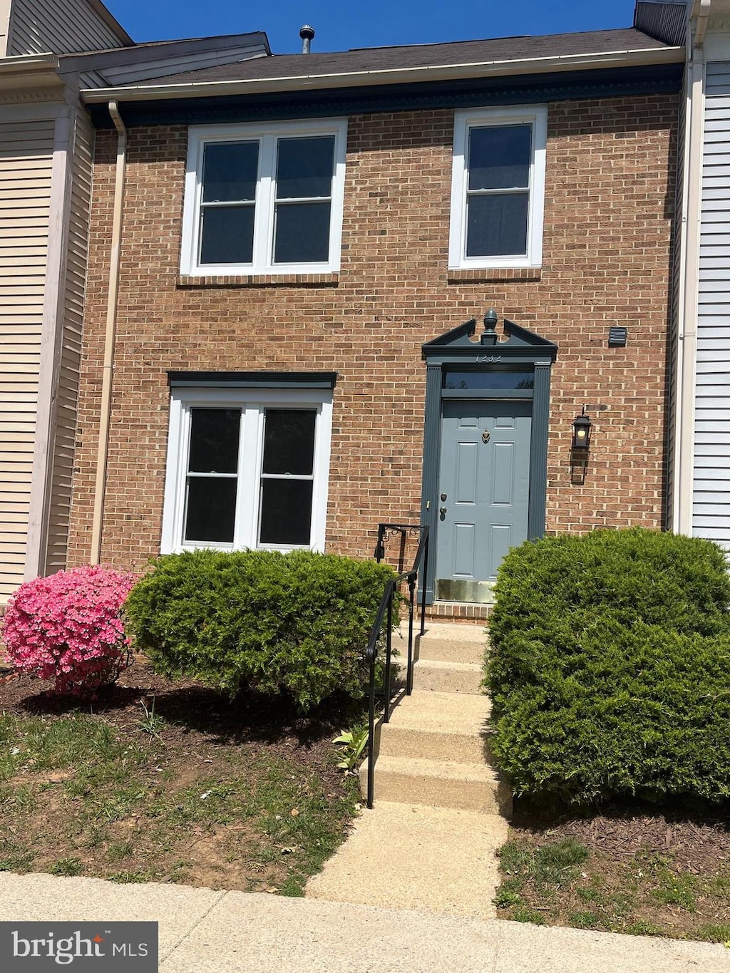 townhome / multi-family property with brick siding
