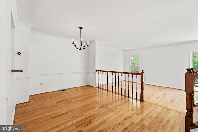 7232 Cherwell Ln, Alexandria, VA 22315 - spare room featuring healthy amount of natural light, wood finished floors, crown molding, a chandelier, and baseboards