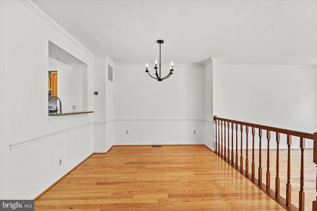 7232 Cherwell Ln, Alexandria, VA 22315 - unfurnished dining area with a chandelier, light wood-type flooring, crown molding, and baseboards