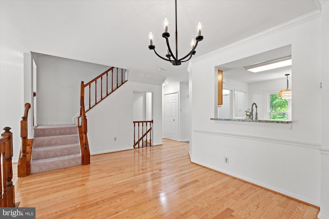 7232 Cherwell Ln, Alexandria, VA 22315 - unfurnished living room featuring wood finished floors, ornamental molding, a chandelier, stairway, and baseboards