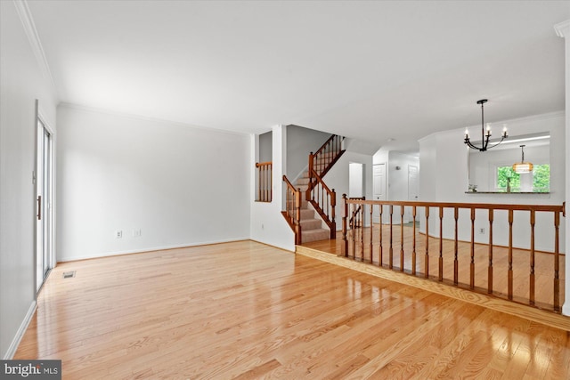 7232 Cherwell Ln, Alexandria, VA 22315 - empty room featuring ornamental molding, light wood-style flooring, a chandelier, and stairway