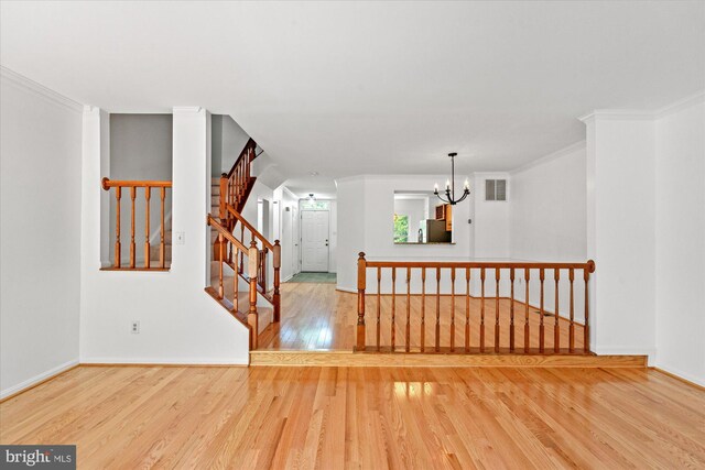 7232 Cherwell Ln, Alexandria, VA 22315 - spare room featuring wood finished floors, ornamental molding, a chandelier, stairs, and baseboards