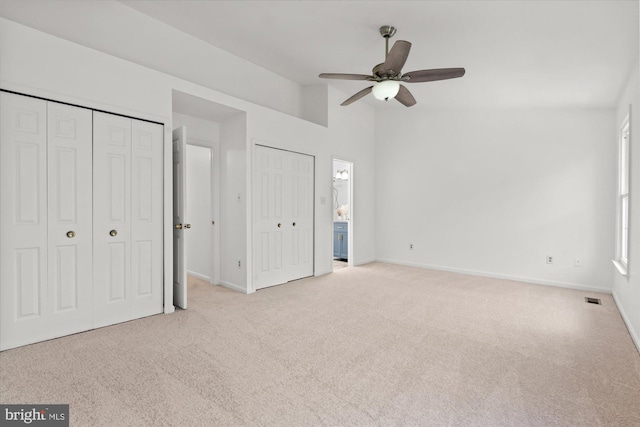 7232 Cherwell Ln, Alexandria, VA 22315 - unfurnished bedroom featuring carpet, lofted ceiling, multiple closets, baseboards, and connected bathroom