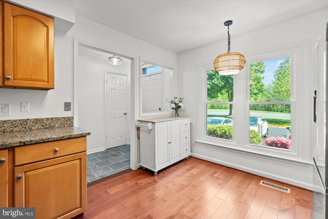 7232 Cherwell Ln, Alexandria, VA 22315 - kitchen with light wood-type flooring, pendant lighting, and stone countertops