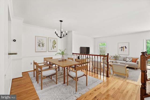 7232 Cherwell Ln, Alexandria, VA 22315 - dining area with healthy amount of natural light, light wood-style floors, a chandelier, and ornamental molding